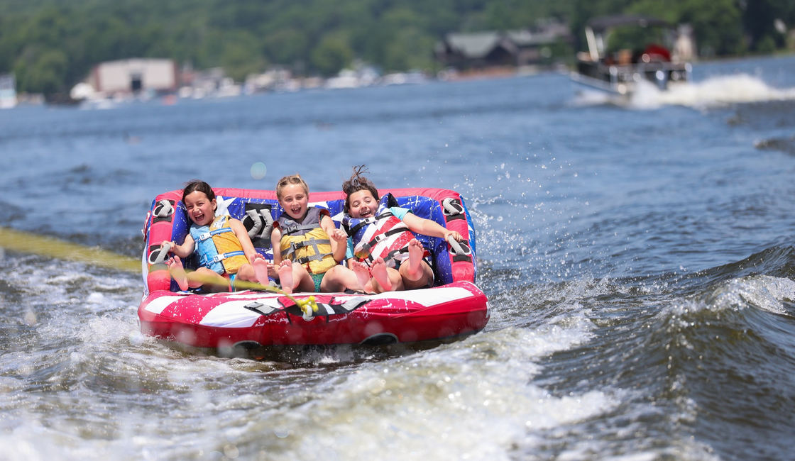 Campers riding a tube across Willow Lake